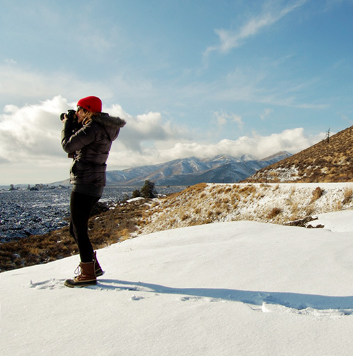 Image of Samantha Mitchell on a snowy mountain taking a photography.